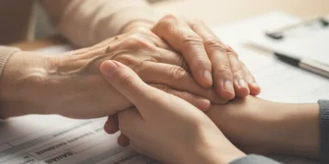 Hands offering comfort, symbolising Bereavement Support Payment
